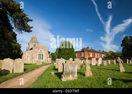 Warm evening sunshine on the church and churchyard of St Andrew's in the village of Glaston, Rutland, England. Stock Photo