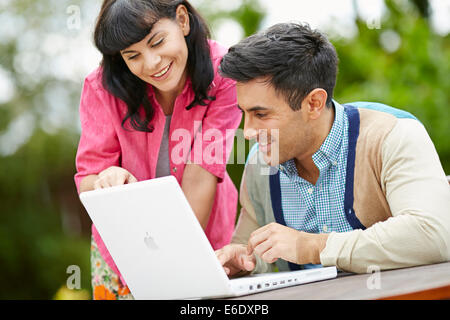 Couple browsing web using laptop Stock Photo