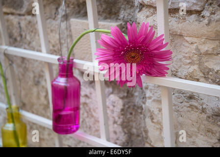Pink gerbera flower in pink vase Stock Photo