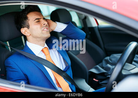 Tired man driving car Stock Photo