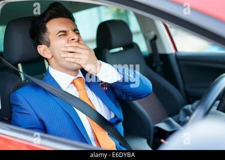 Tired man driving car Stock Photo