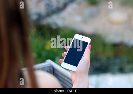 A woman holding an iPhone. Stock Photo