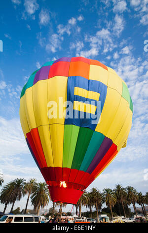 Hot air balloon lifting off just after sunrise Stock Photo