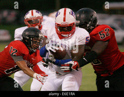 Largo, Florida, US. 21st Aug, 2014. Pinellas Park running back Kel-El Williams (5), center, skirts tackle attempts by Dunedin High School's Alejandro Cuellar (12), left, and Ikkeem Howard (52) during Thursday's (8/21/14) preseason football jamboree game hosted at Largo High School. © Douglas R. Clifford/Tampa Bay Times/ZUMA Wire/Alamy Live News Stock Photo