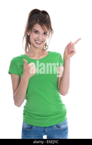 Isolated adorable girl showing and presenting with her finger and making thumb up gesture over white. Stock Photo