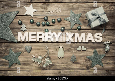 Merry Xmas: christmas greeting card with blue and white decoration on wooden background. Stock Photo