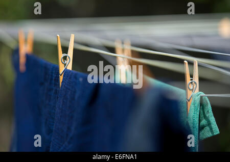 Wooden pegs holding up washing on a washing line Stock Photo