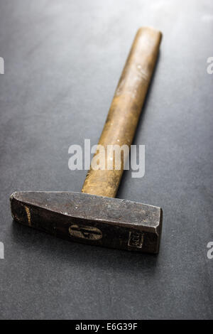 Old used hammer on table, close up Stock Photo
