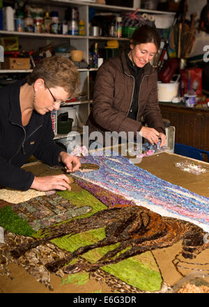 Eyam, Derbyshire, UK. 23rd August, 2014. Volunteers petalling the Requisitioning of Horses 2014 well dressing, to be blessed Saturay 23rd August at the start of Wakes Week. Credit:  Neil McAllister/Alamy Live News Stock Photo