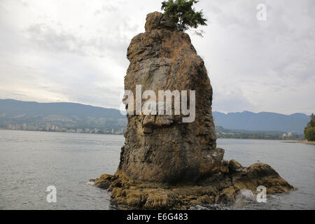 Siwash Rock is a famous rock outcropping in Vancouver, British Columbia, Canada's Stanley Park. Stock Photo