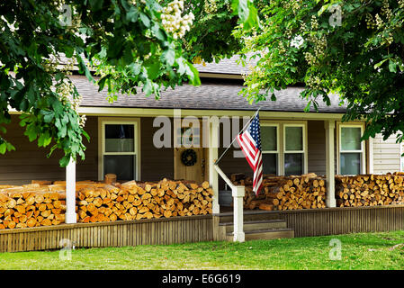 House in Joseph Oregon with firewood stacked on porch. Stock Photo