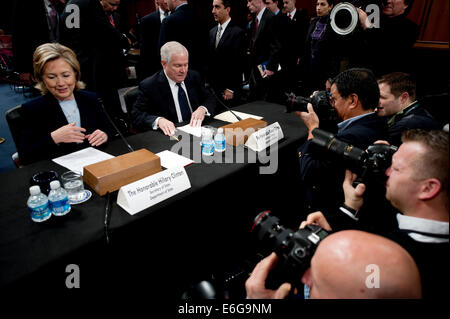 US Secretary of State Hillary Rodham Clinton and Secretary of Defense Robert M. Gates prepare to testify at the Senate Foreign Relations Committee on the troop serge sending an additional 30,000 troops to Afghanistan in the Hart Senate Office Building December 3, 2009 in Washington, DC. Stock Photo