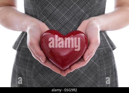 Isolated woman holding a red heart in her hands. Idea for different concepts. Stock Photo