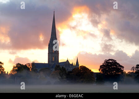 A layer of mist over the water meadows beside Salisbury Cathedral in Wiltshire, England, photographed at sunrise. Stock Photo