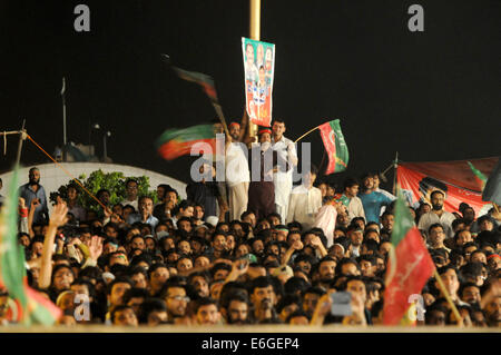 Islamabad, Pakistan. 22nd Aug, 2014. Supporters of opposition leader Imran Khan gather during an anti-government protest in front of the Parliament building in Islamabad, capital of Pakistan, on Aug. 22, 2014. As there is no let up in protests against the government in Pakistan by two political parties, the country's Senate on Friday unanimously passed a resolution rejecting the unconstitutional demands for resignation of Prime Minister and dissolution of Assemblies. Credit:  Ahmad Kamal/Xinhua/Alamy Live News Stock Photo