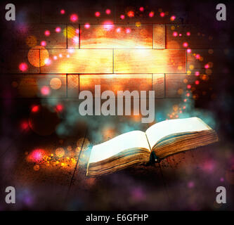 Old book with magic Ray of light Stock Photo
