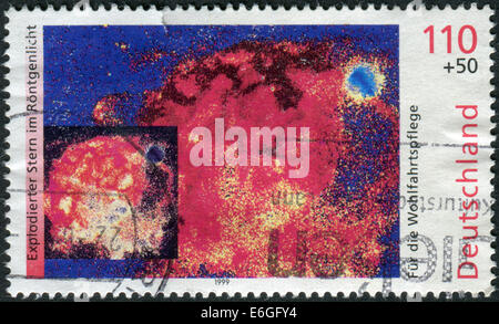 GERMANY - CIRCA 1999: Postage stamp printed in Germany, shows the X-ray image of exploding star, circa 1999 Stock Photo