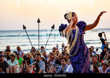 Hawaii,Hawaiian,Honolulu,Waikiki Beach,Kuhio Beach Park,Hyatt Regency Hula Show,free audience,Pacific Ocean,woman female women,dancer,torch,lit,muumuu Stock Photo