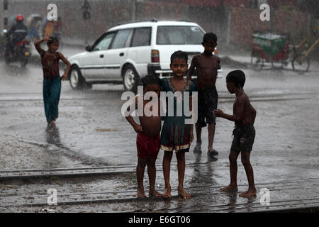 Dhaka, Bangladesh. 23rd Aug, 2014. Slum children enjoying rain in Dhaka.Dhaka is the second most vulnerable city to serious flooding among nine coastal cities globally and will remain so until 2100 unless measures to counter the threat are taken, an international study suggests Credit:  Zakir Hossain Chowdhury/ZUMA Wire/Alamy Live News Stock Photo