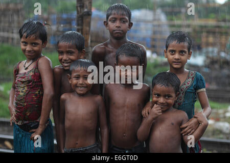 Dhaka, Bangladesh. 23rd Aug, 2014. Slum children enjoying rain in Dhaka.Dhaka is the second most vulnerable city to serious flooding among nine coastal cities globally and will remain so until 2100 unless measures to counter the threat are taken, an international study suggests Credit:  Zakir Hossain Chowdhury/ZUMA Wire/Alamy Live News Stock Photo