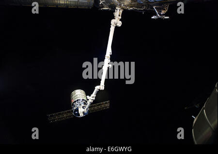 The International Space Station's Canadarm 2 prepares to release the Orbital Sciences Corporation commercial cargo craft Cygnus Stock Photo