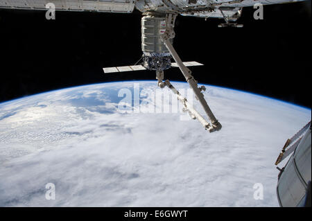 The International Space Station's Canadarm 2 prepares to release the Orbital Sciences Corporation commercial cargo craft Cygnus after a month attached to the orbital outpost August 15, 2014 in Earth Orbit. Stock Photo