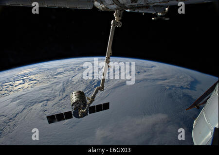 The International Space Station's Canadarm 2 prepares to release the Orbital Sciences Corporation commercial cargo craft Cygnus after a month attached to the orbital outpost August 15, 2014 in Earth Orbit. Stock Photo