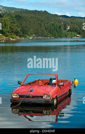 A Subaru passenger car turned into a boat floating on a lake, Norway Stock Photo