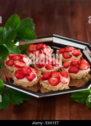 Seven strawberry cupcakes on a silver plate. Stock Photo