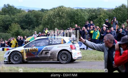 Baumholder, Germany. 23rd Aug, 2014. Jari-Matti Latvala and co-driver Mikka Anttila (both Finland) pass the special stage of the ADAC Rally Deutschland part of the WRC Rally Championships at the military training grounds in Baumholder, Germany, 23 August 2014. Photo: THOMAS FREY/dpa/Alamy Live News Stock Photo