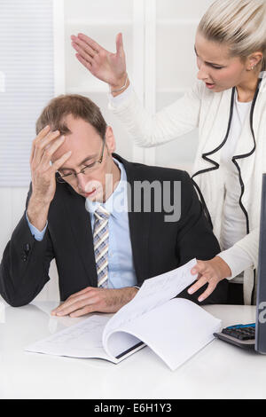 Trouble and harassment under business colleagues: bullying and gossip man and woman. Stock Photo