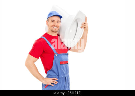 Plumber carrying a toilet bowl isolated on white background Stock Photo