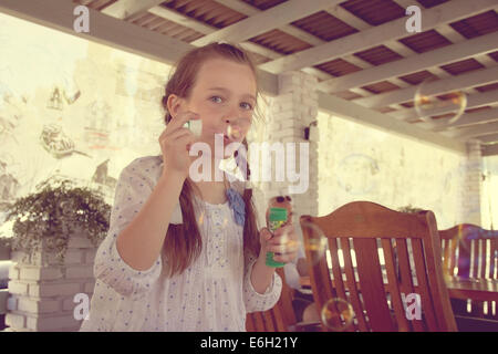 girl blow bubbles Stock Photo