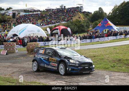 Baumholder, Germany. 23rd Aug, 2014. Mikko Hirvonen and co-driver Jarmo Lehtinen (both Finland) pass the special stage of the ADAC Rallye Deutschland part of the WRC Rallye Championships at the military training grounds in Baumholder, Germany, 23 August 2014. Photo: THOMAS FREY/dpa/Alamy Live News Stock Photo