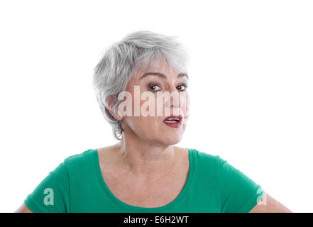Isolated disappointed mature woman wearing green shirt looking angry and doubtful. Stock Photo