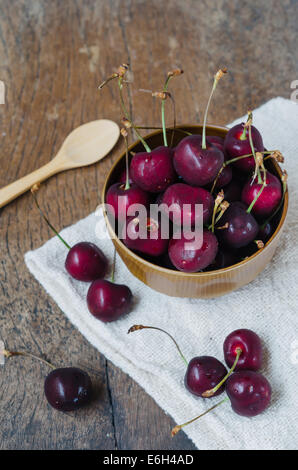 fresh cherries in bowl ,  on wooden table  background Stock Photo