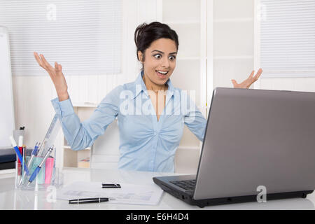 Successful happy businesswoman looking happy at the screen reading a positive message. Stock Photo