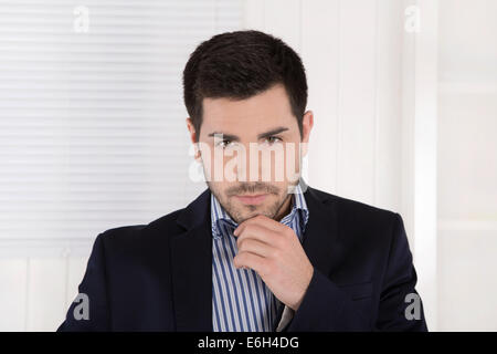 Portrait of a serious arrogant isolated businessman in the office. Stock Photo