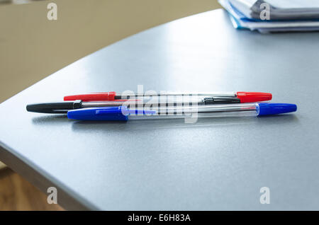 Three multicolor felt pens on wooden desk Stock Photo