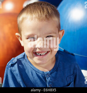 Six year old boy child, milk tooth smiling, playground on background Stock Photo