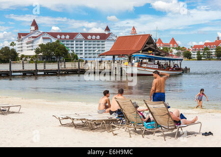 Disney's Polynesian Resort guests enjoy the beach overlooking the Grand Floridian Resort in Walt Disney World, Florida Stock Photo