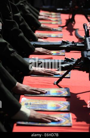 Kabul, Afghanistan. 24th Aug, 2014. Newly-graduated female Afghan National Army (ANA) officers take oath during their graduation ceremony in Kabul, Afghanistan on Aug. 24, 2014. A total of 30 female army officers graduated from Kabul Military Training Center (KMTC) on Sunday and commissioned to ANA, General Aminullah Paktiani commander of KMTC said. Credit:  Ahmad Massoud/Xinhua/Alamy Live News Stock Photo