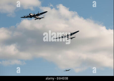Battle of Britain Memorial Flight with Avro Lancasters PA474 'Thumper' and the Canadian Warplane Heritage Museum's 'Vera', and Spitfire PS915 (Mk PRXIX) at the Dawlish Air Show. Stock Photo