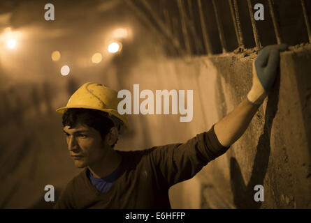 Tehran, Iran. 24th Aug, 2014. August 24, 2014 - Tehran, Iran - An Iranian worker rests as he stand at a workshop of the northern part of Tehran's Subway Line 3. Subway line 3 with 37 km (23 miles) long and 28 stations will be the main public transportation and connection between southwest and northeast of Tehran. Morteza Nikoubazl/ZUMAPRESS © Morteza Nikoubazl/ZUMA Wire/Alamy Live News Stock Photo