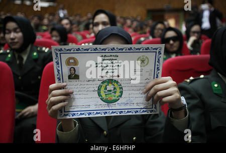 Kabul, Afghanistan. 24th Aug, 2014. A newly-graduated female Afghan National Army (ANA) officer shows her certificate during the graduation ceremony in Kabul, Afghanistan on Aug. 24, 2014. A total of 30 female army officers graduated from Kabul Military Training Center (KMTC) on Sunday and commissioned to ANA, General Aminullah Paktiani commander of KMTC said. Credit:  Ahmad Massoud/Xinhua/Alamy Live News Stock Photo