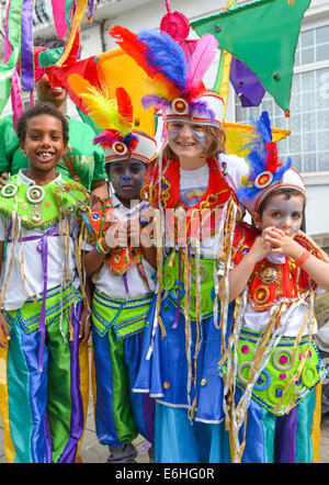 Notting Hill, London, UK. 24th August 2014. Four children in costume at the parade. Sunday is Children's Day at the Notting Hill Carnival of Carribean culture of music, dancing, food and drink. Credit:  Matthew Chattle/Alamy Live News Stock Photo