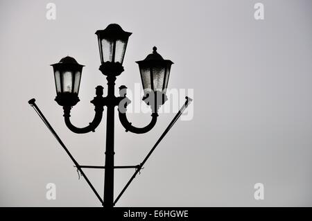 one typical traditional Maltese street light in Valletta with two flag poles ready for a celebration Stock Photo