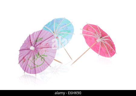 Three colored cocktail umbrellas. Isolated on white background Stock Photo