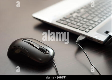 Computer mouse and laptop computer Stock Photo