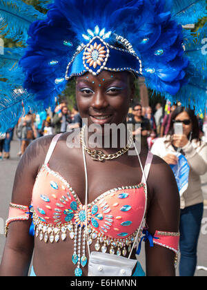 London, UK. 24th Aug, 2014. A young girl in blue headdress and peach custome enjoys the children's day parade at the Notting Hill Carnival London, UK. Credit:  Mamusu Kallon/Alamy Live News Stock Photo